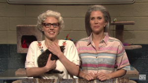 Barbara DeDrew (Kate McKinnon) and Furonica (Kristen Wiig) show off the cats available for adoption during the Thanksgiving Catacopia giveaway.