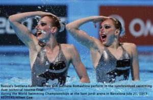 Russia's Svetlana Kolesnichenko and Svetlana Romashina perform in the synchronised swimming duet technical routine final during the World Swimming Championships at the Sant Jordi arena in Barcelona July 21, 2013. REUTERS/Albert Gea