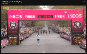 Eliud Kipchoge goes through the finish line in one hour, 59 minutes and 40 seconds.