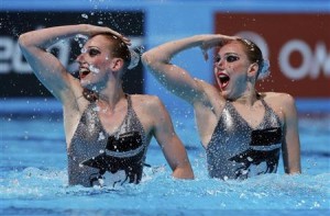 Russia's Svetlana Kolesnichenko and Svetlana Romashina perform in the synchronised swimming duet technical routine final during the World Swimming Championships at the Sant Jordi arena in Barcelona July 21, 2013. REUTERS/Albert Gea