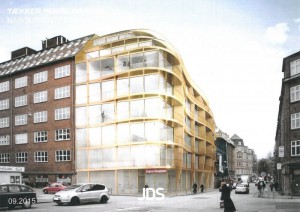 Arkitektfirmaet JDS har tegnet en tilbygning med store glaspartier, gyldent facademateriale og altaner mod gaden.